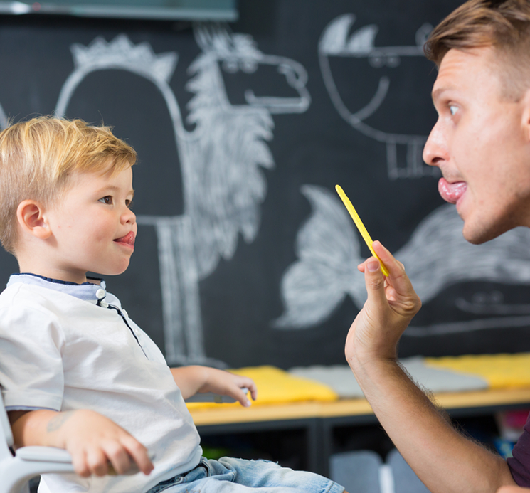 A doctor pointing at a spinal x-ray image while explaining it to a colleague.