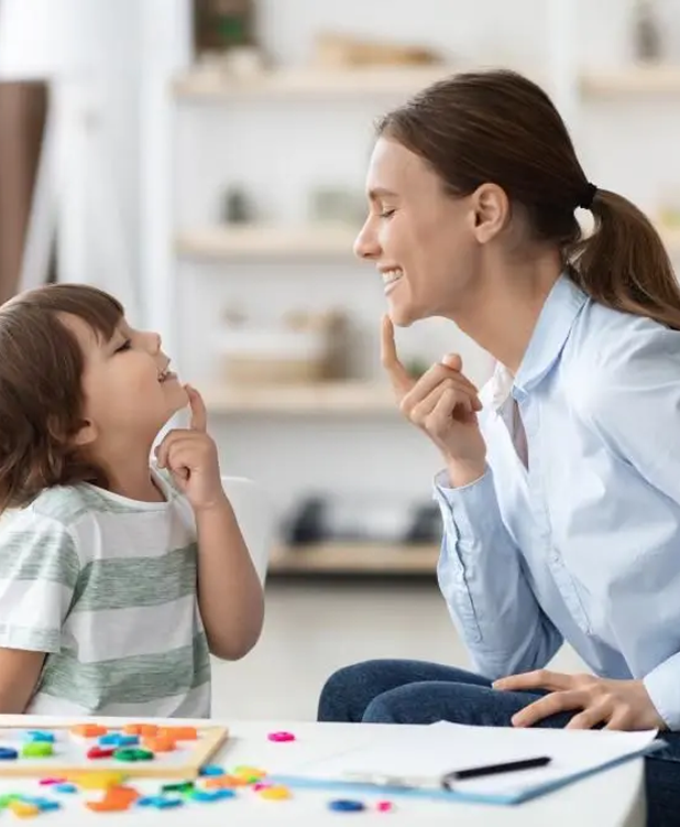 A friendly receptionist at a clinic desk, smiling and ready to help.